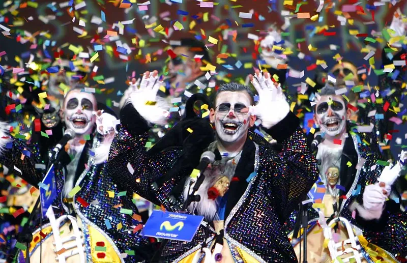 Costumed singers with painted faces amid confetti at the Tenerife Carnival