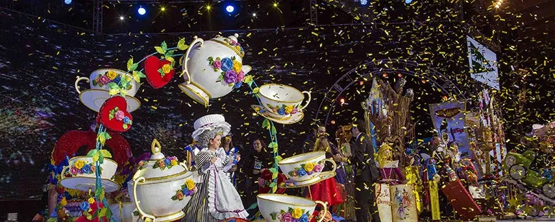 Stage set with giant teapots and cups, costumed performers and golden confetti at the Tenerife Carnival