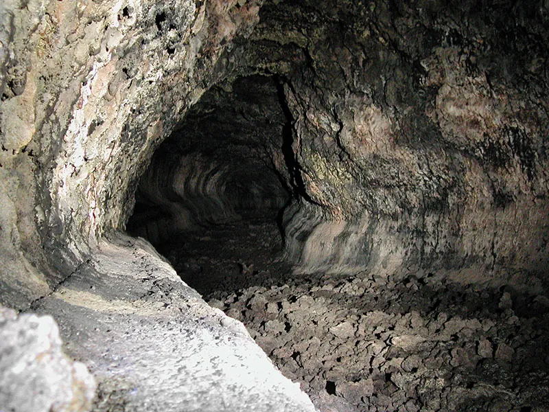 Inside the Cueva del Viento volcanic cave, with lava walls and a rocky floor