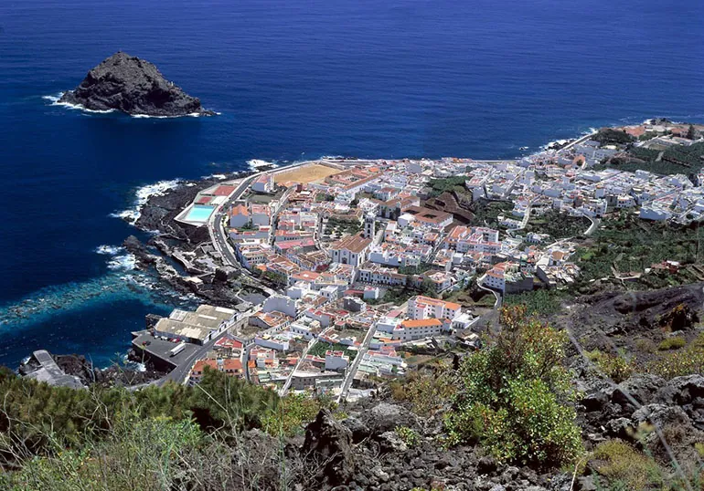Garachico from above on its lava platform, with the Roque islet out in the ocean