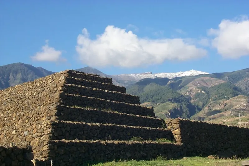 Lava-stone tiers of one of the Pyramids of Güímar, with mountains in the background