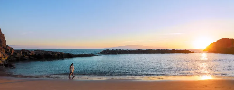 Sunset at Playa Abama with a figure on the shoreline and La Gomera on the horizon