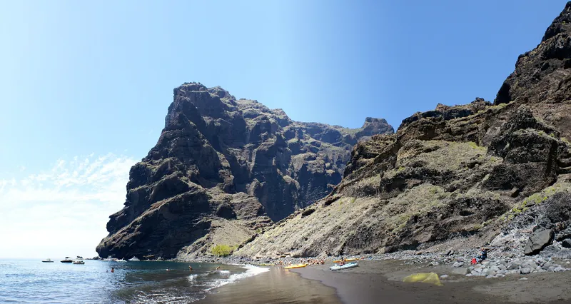 Boats and kayaks at Playa de Masca, beneath imposing cliffs at the mouth of the gorge