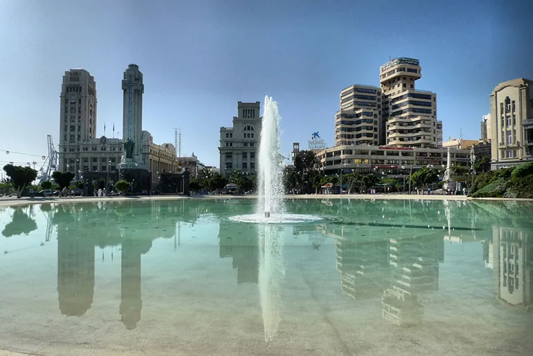 Fountain and large pool in Plaza de España reflecting the buildings, Santa Cruz de Tenerife